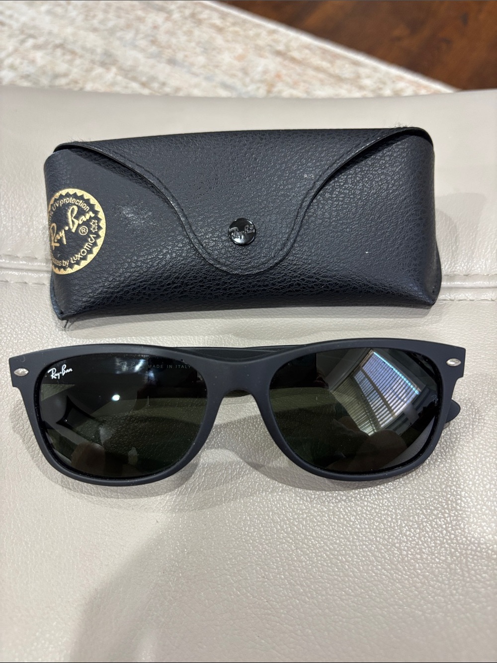 Ray-Ban New Wayfarer matte black sunglasses with classic green G-15 lenses.